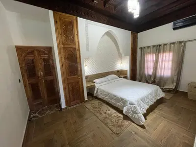 a bedroom with a white bed and a window at Sandy farm in Ouled el guerne