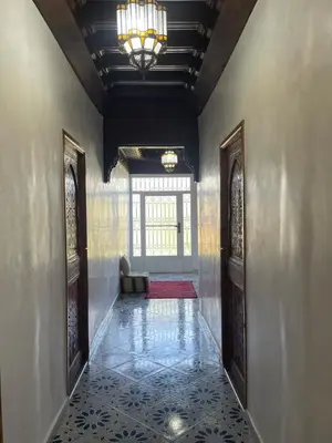 a hallway with two doors and a chandelier at Sandy farm in Ouled el guerne