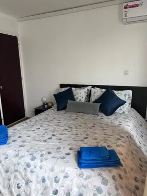 a bedroom with a large bed with blue pillows on it at Escapade à Fes in Fès
