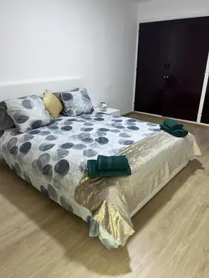 a bedroom with a large bed with a comforter at Escapade à Fes in Fès