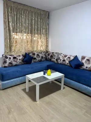 a blue couch with a coffee table in a living room at Escapade à Fes in Fès