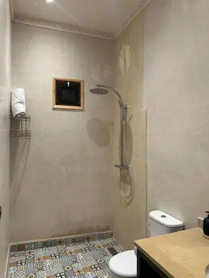 a bathroom with a shower with a toilet and a sink at bled ghazal in Marrakech