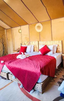 a bedroom with a large bed in a tent at Layali Luxury Desert Camp in Merzouga