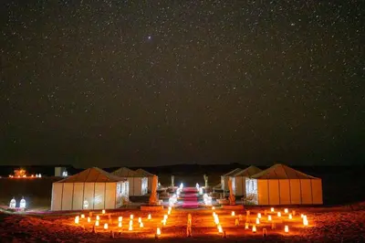 a group of tents under a starry sky at night at Layali Luxury Desert Camp in Merzouga