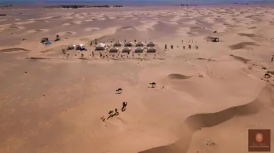 a group of people standing in the desert at Luxury beldi camp in Merzouga