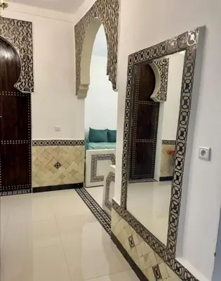 a bathroom with a mirror on the wall at Dar House Fez in Fès
