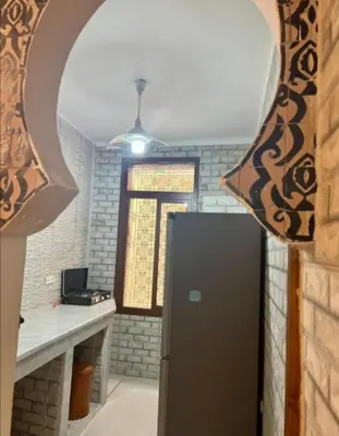 a kitchen with a refrigerator in a room at Dar House Fez in Fès