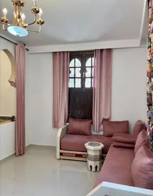 a living room with a couch and a window at Dar House Fez in Fès