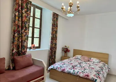 a bedroom with a bed and a window and a chair at Dar House Fez in Fès