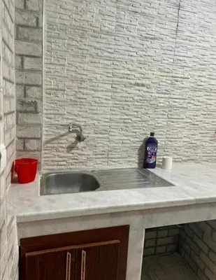 a sink with a bottle of soap on top of it at Dar House Fez in Fès