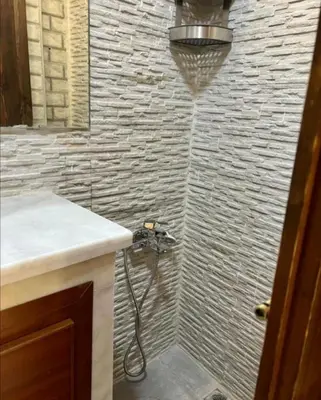 a bathroom with a shower with a camera in it at Dar House Fez in Fès