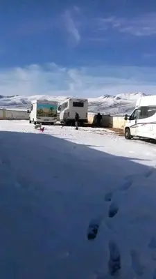 three trailers parked in a snow covered parking lot at Gueste housse ait hani in Aït Hani