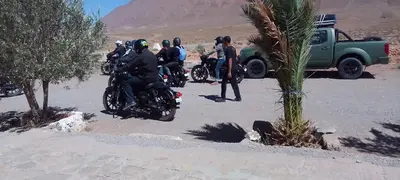 a group of people riding motorcycles in the desert at Gueste housse ait hani in Aït Hani