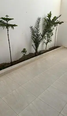 a room with some plants and a white wall at Casa de playa in Oulad Akkou