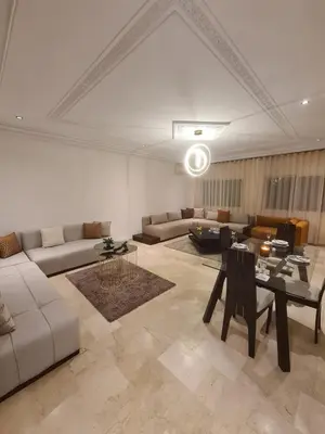 a living room with a couch and a table at Prestige Immo in Fès