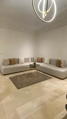 a living room with a couch and a table at Prestige Immo in Fès