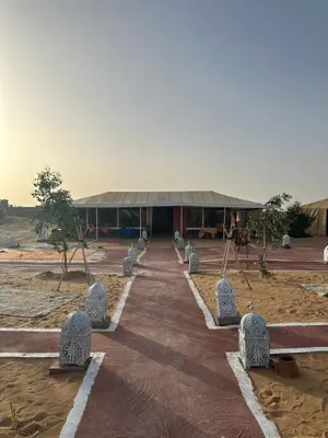 a building with a row of stone statues in front of it at SANDSTAR LUXURIOUS CAMP air-conditioned in Merzouga