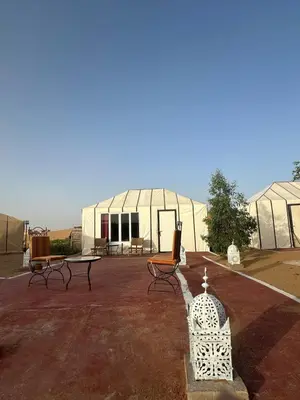 a building with benches in front of it at SANDSTAR LUXURIOUS CAMP air-conditioned in Merzouga