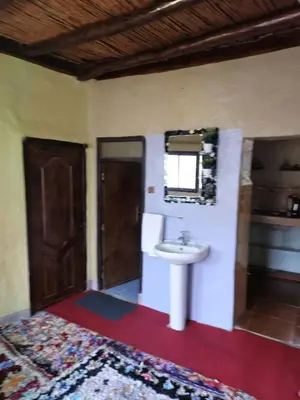 a bathroom with a sink and a mirror on the wall at Gite Soleil Private House in Tacheddirt