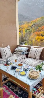 a living room with a table with food on it at Gite Soleil Private House in Tacheddirt
