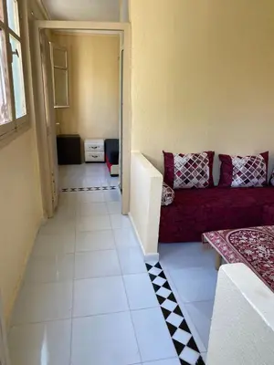 a living room with a red couch in a room at siti fadma ourika Marrakech in Aghbalou
