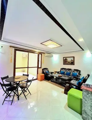 a living room with a couch and a table at Premium Apartment Fes - Route Ain Chkef in Fès