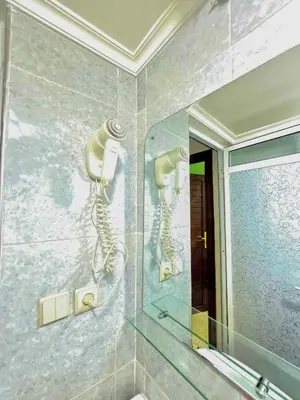 a bathroom with a shower and a mirror at Premium Apartment Fes - Route Ain Chkef in Fès