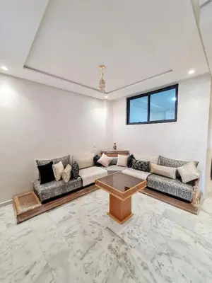 a living room with a couch and a table at Premium Apartment Fes - Route Ain Chkef in Fès