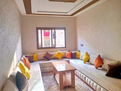 a living room with a couch with colorful pillows at New furnished apartment in Meknès