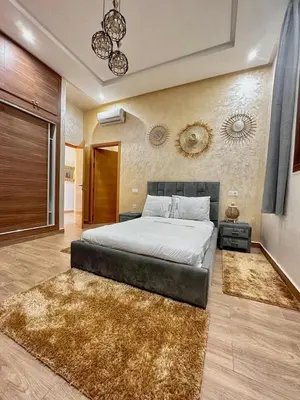 a bedroom with a large bed and a rug at Tasnim VILLA in Marrakech