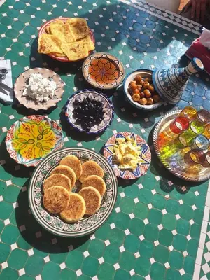 a table topped with plates of food on a table at Tasnim VILLA in Marrakech