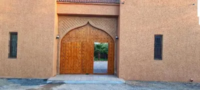 a wooden door in the side of a building at Tasnim VILLA in Marrakech