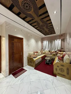 a living room with two couches and a wooden door at house Perfect well equipped in Midelt