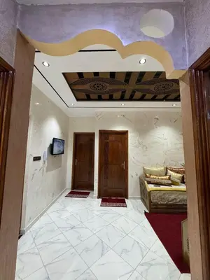 a room with two beds and a tv on a ceiling at house Perfect well equipped in Midelt