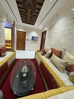 a living room with two beds and a glass table at house Perfect well equipped in Midelt