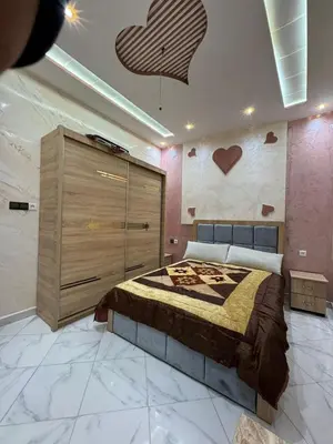 a bedroom with a bed and hearts on the wall at house Perfect well equipped in Midelt