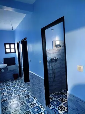 a bathroom with a mirror and a tub and a sink at Gîte Assonfo Tachdirt in Tacheddirt