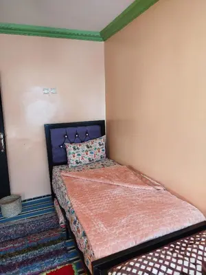 a bedroom with a bed in a room at Gîte Assonfo Tachdirt in Tacheddirt