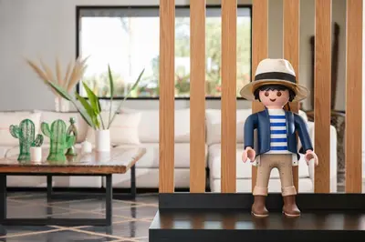 a doll in a hat standing on a table in a living room at Villa Shelter in El Bougaria