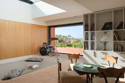 a living room with a table and a large window at Villa Shelter in El Bougaria