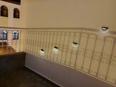 a hallway with a fence with lights on the wall at Appartement confortable in Fès