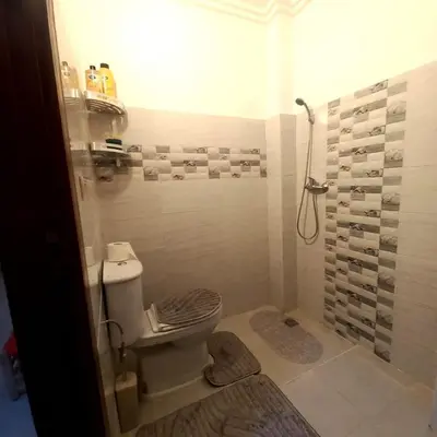 a bathroom with a toilet and a shower at Appartement confortable in Fès