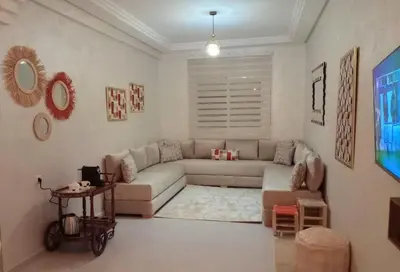 a living room with a couch and a table at Appartement confortable in Fès