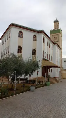 a large white building with a clock tower on top at Appartement confortable in Fès
