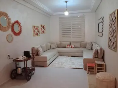 a living room with a couch and a table at Appartement confortable in Fès