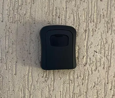 a black cell phone sitting on the ground at Appartement luxueuse au centre ville de Fès in Fès