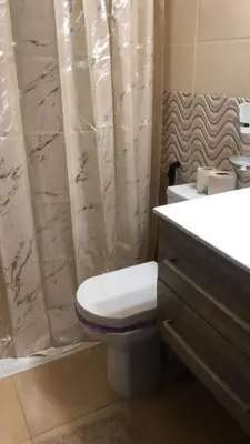 a bathroom with a toilet and a shower curtain at Appartement luxueuse au centre ville de Fès in Fès