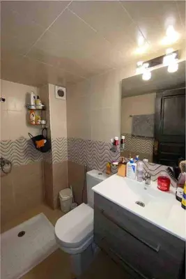 a bathroom with a sink and a toilet and a mirror at Appartement luxueuse au centre ville de Fès in Fès