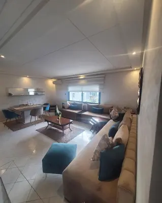 a living room with a couch and a table at Appartement luxueuse au centre ville de Fès in Fès