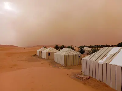 a row of white buildings in the desert at Merzouga morocco in Tisserdmine